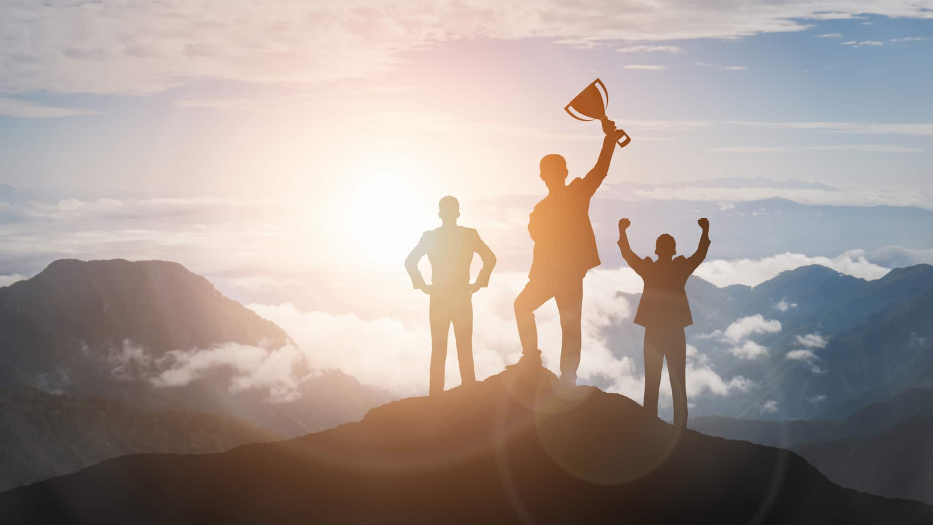 Victory Concept, Group of businesspeople on top of a mountain raising hands with a trophy